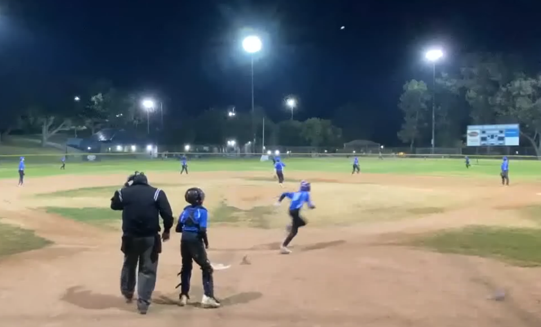 Youth baseball player hitting with USA-certified bat